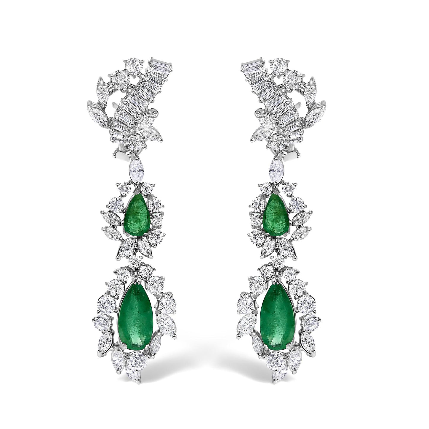 Pair of white metal drop earrings with pear-shaped green gemstones surrounded by various round and marquise-shaped white gemstones, shown from a front angle on a white background.