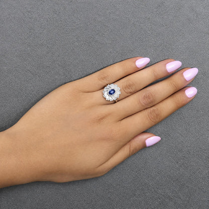 14K White Gold Oval Blue Sapphire and 1/5 Cttw Diamond Sunburst Halo Cocktail Ring