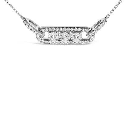 Close-up front angle of a white necklace featuring a rectangular pendant with three white gemstones in miracle settings surrounded by smaller white gemstones in prong settings along the pendant and chain.