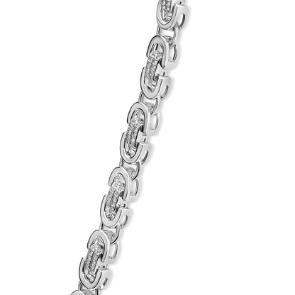 Close-up angled view of a white necklace featuring linked sections with embedded round prong-set white gemstones.