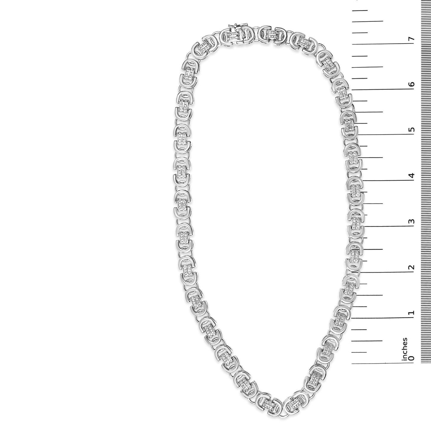 White necklace with linked oval-shaped sections, each containing multiple small round white gemstones in prong settings, shown flat on a white background with a ruler scale on the right side, top-down angle.