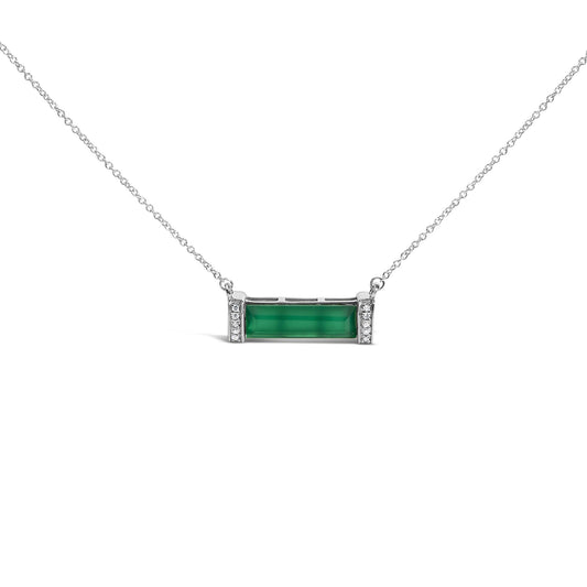 Front-facing shot of a white necklace featuring a horizontal rectangular green gemstone in a channel setting, flanked on both sides by vertical rows of small round white gemstones in pave setting.
