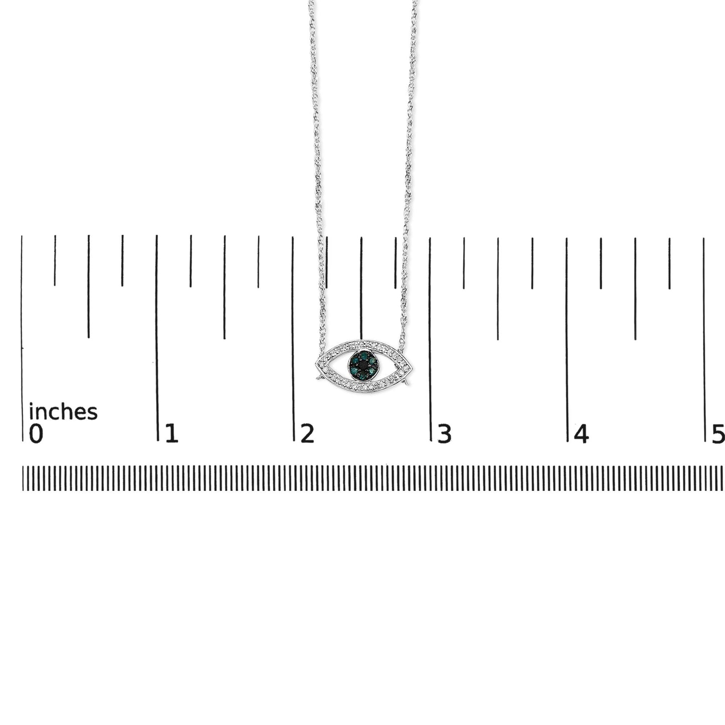 White metal necklace with an eye-shaped pendant featuring round blue gemstones set in the center with a shared prong setting and surrounded by round white gemstones in a prong setting, shown on a scale from a front-facing angle.