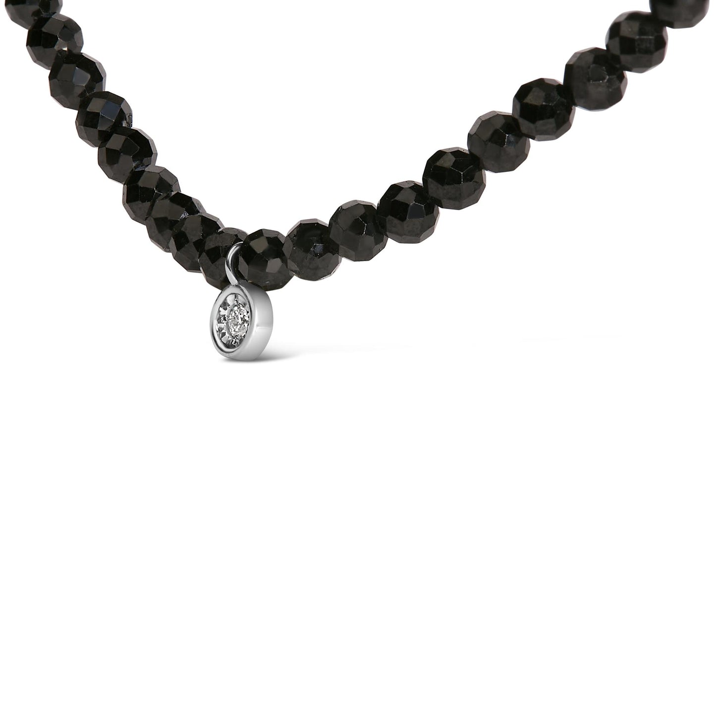 Close-up front angle of a white necklace featuring round black gemstones with a small round white gemstone pendant in a miracle setting.