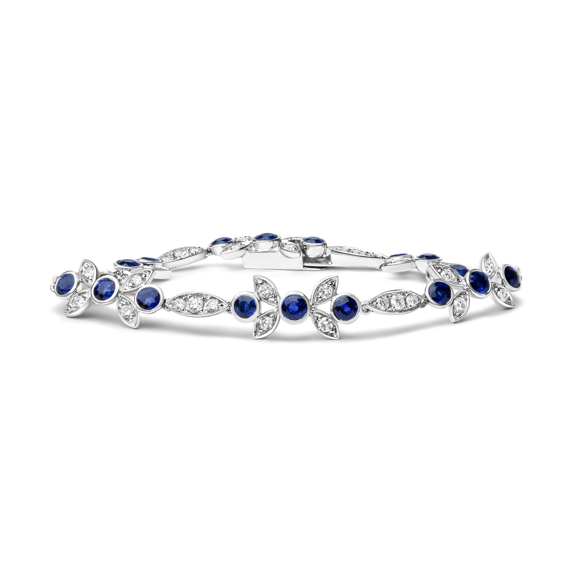 White metal bracelet with alternating round blue gemstones in bezel settings and marquise-shaped segments with white gemstones in prong settings, shown from a side angle.