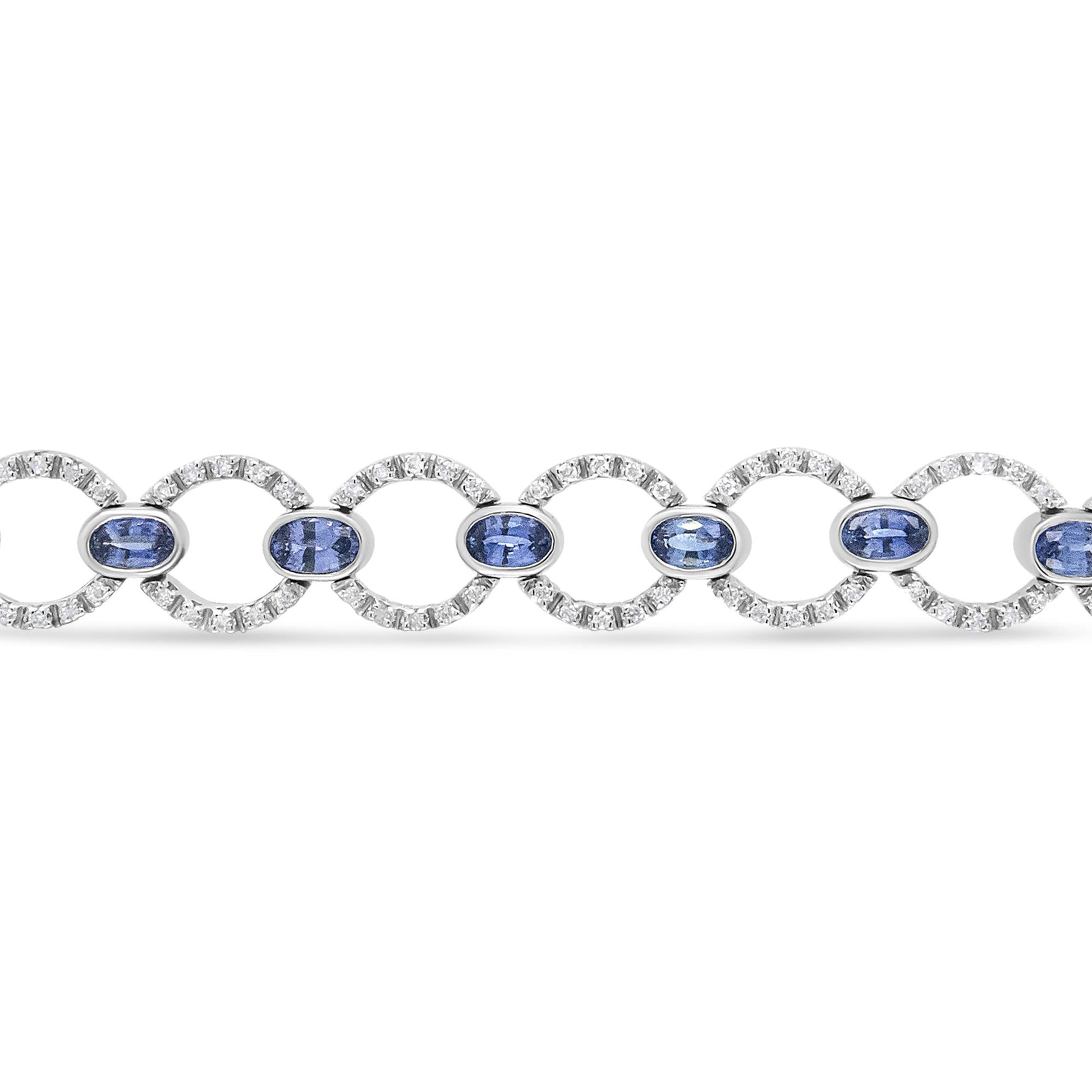 Bracelet shown from the front angle featuring alternating circular links set with small white gemstones and oval blue gemstones in bezel settings.