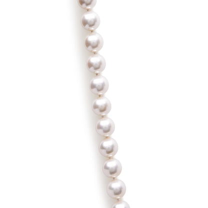 Close-up front angle of a white pearl bead necklace segment on a white background.
