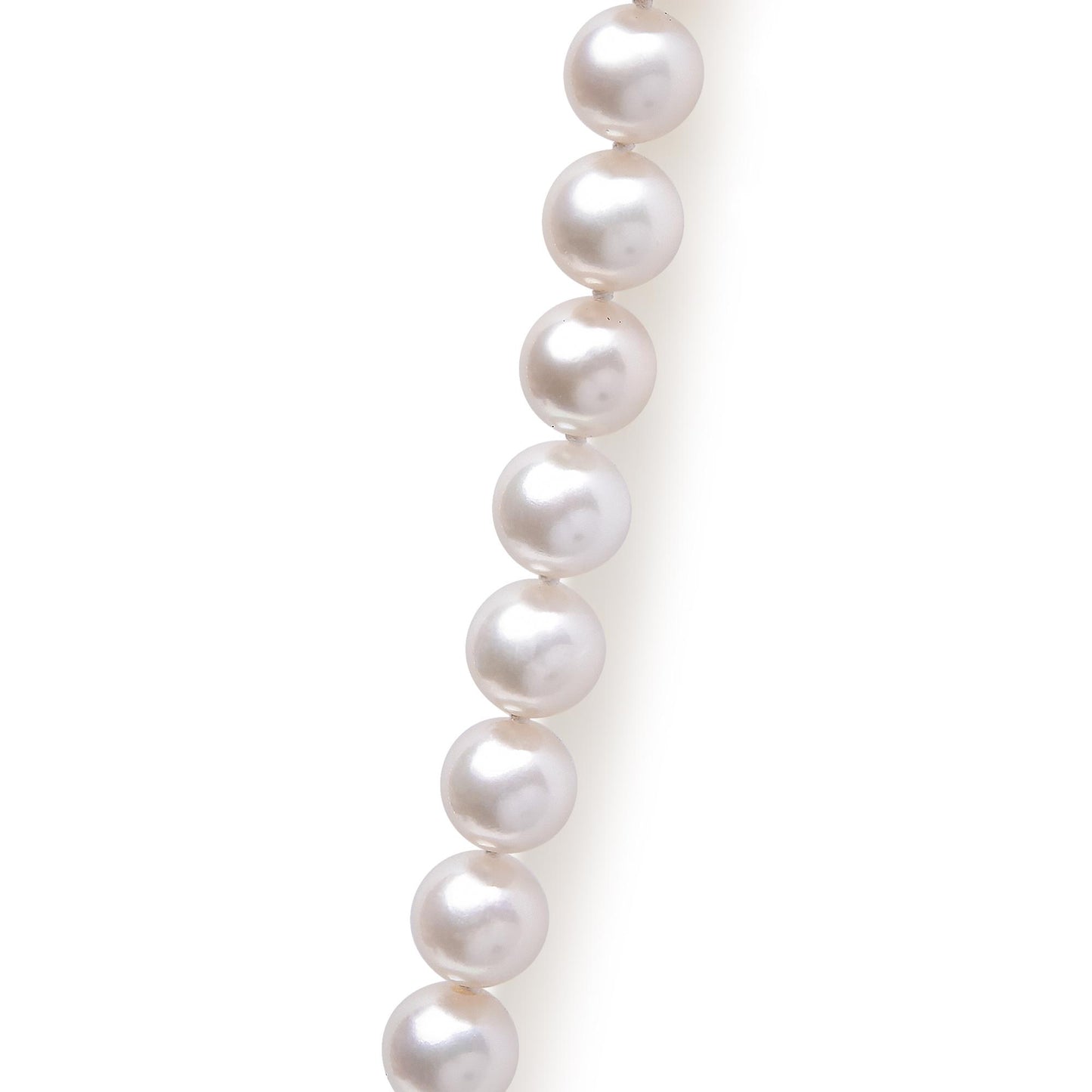 Close-up side view of a yellow metal necklace with round white pearls.