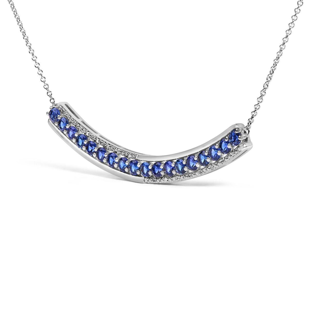 Close-up front angle of a curved white metal necklace pendant featuring prong-set round blue gemstones bordered by prong-set round white gemstones, shown on a white background.