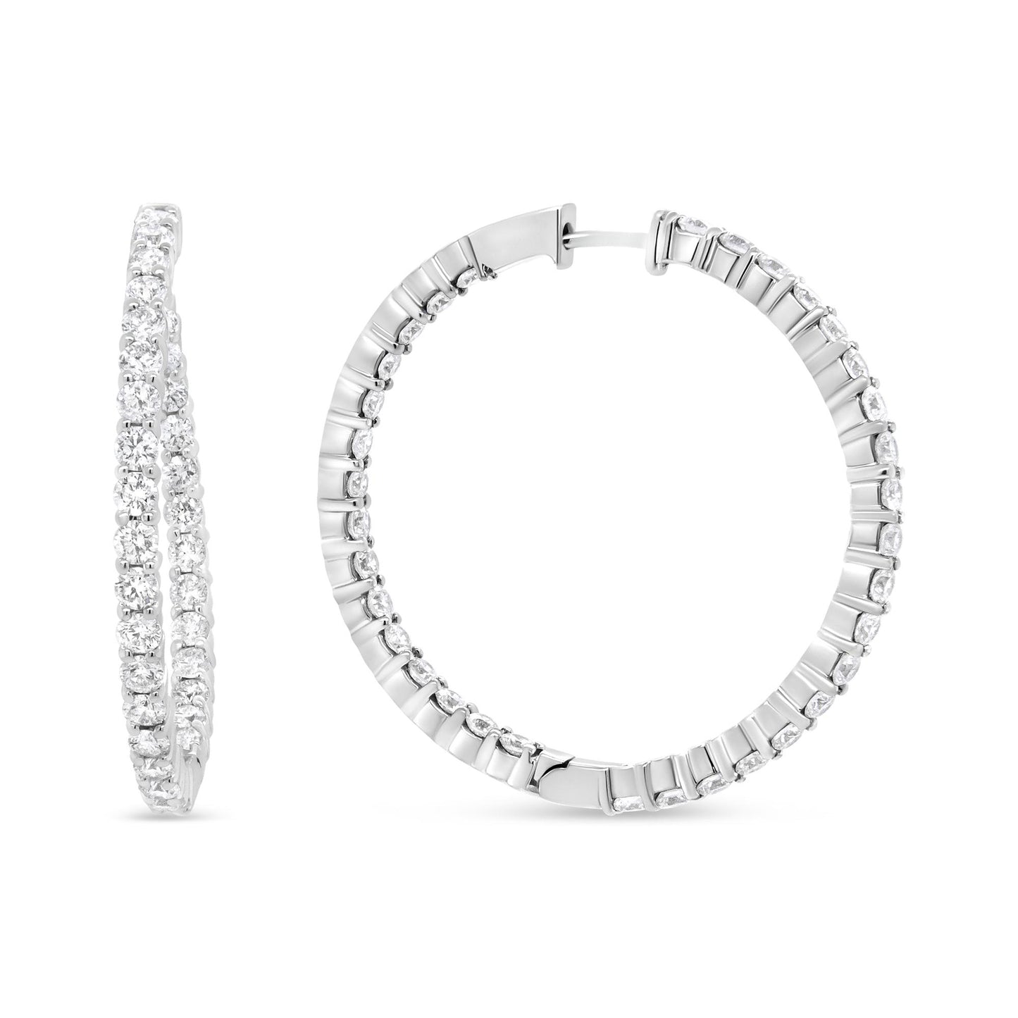 Close-up front and side view of white metal hoop earrings set with round white gemstones in prong settings.