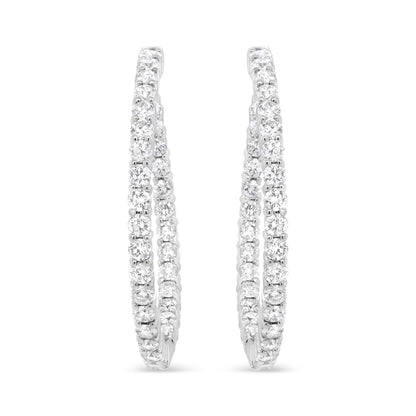 Pair of white metal hoop earrings with two rows of prong-set round white gemstones, shown from the front angle on a white background.