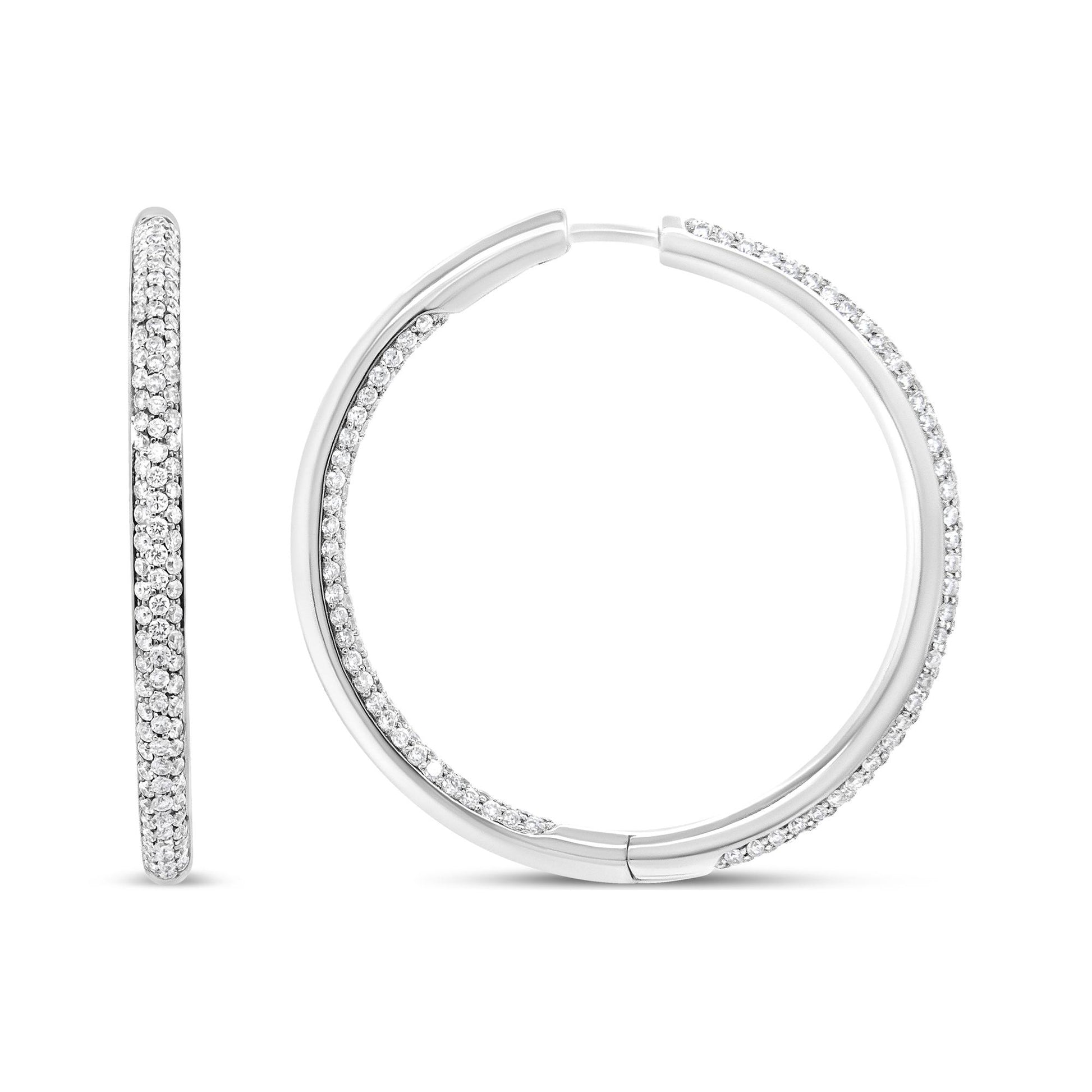 Front and side view of white hoop earrings with round white gemstones in prong setting along the outer edges, shown against a white background.