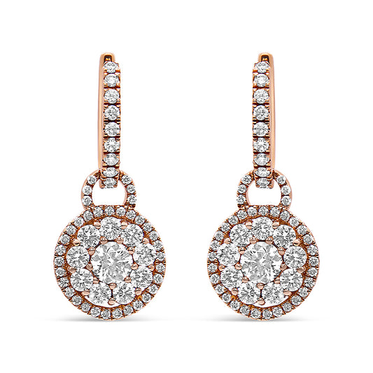Front view of a pair of rose metal drop earrings featuring round white gemstones arranged in a circular cluster design with additional gemstones along the hooks.