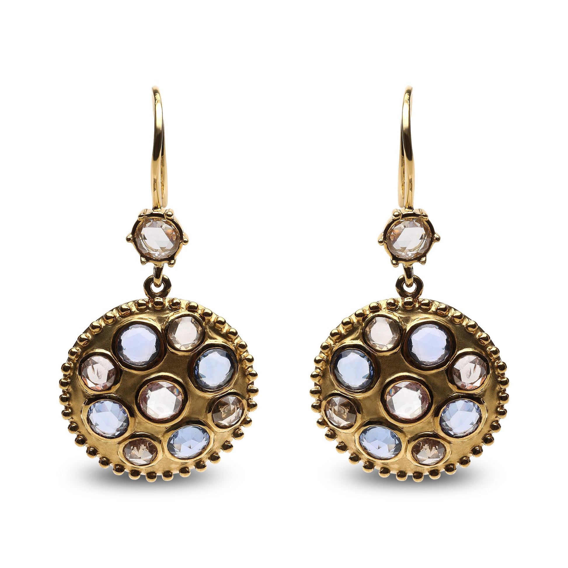 Front-facing shot of yellow metal earrings with round bezel settings featuring blue and brown gemstones and white gemstones in a circular pattern.