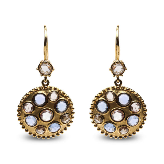 Front-facing shot of yellow metal earrings with round bezel settings featuring blue and brown gemstones and white gemstones in a circular pattern.