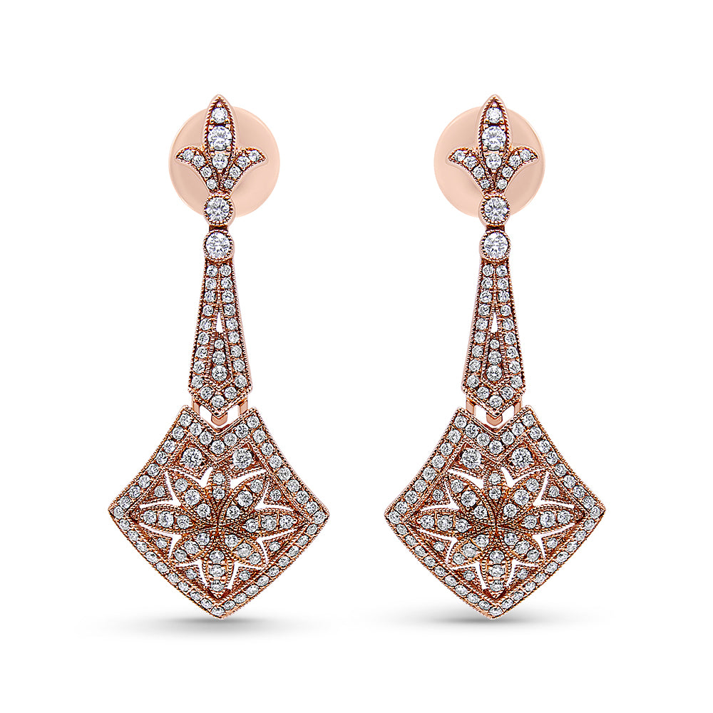 Front-facing shot of a pair of rose metal drop earrings with white round gemstones in prong settings arranged in intricate floral and geometric patterns.