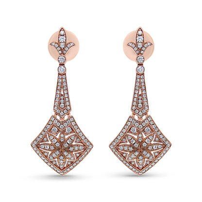 Front-facing shot of a pair of rose metal drop earrings with white round gemstones in prong settings arranged in intricate floral and geometric patterns.