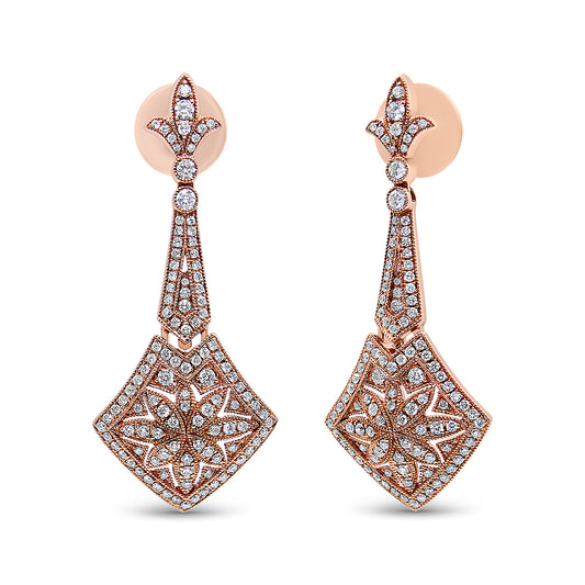 Front-facing shot of a pair of rose-colored metal drop earrings with intricate designs, featuring numerous small white gemstones set throughout in a pattern with prong settings.
