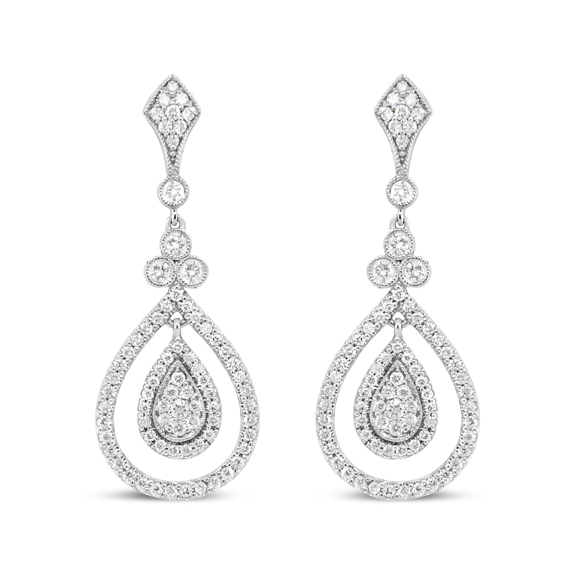 Front view of white metal drop earrings with teardrop and diamond-shaped sections adorned with multiple white gemstones in bezel and prong settings.