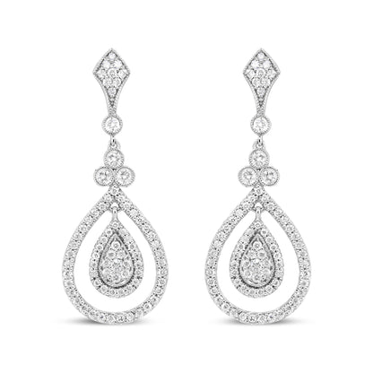 Front view of white metal drop earrings with teardrop and diamond-shaped sections adorned with multiple white gemstones in bezel and prong settings.