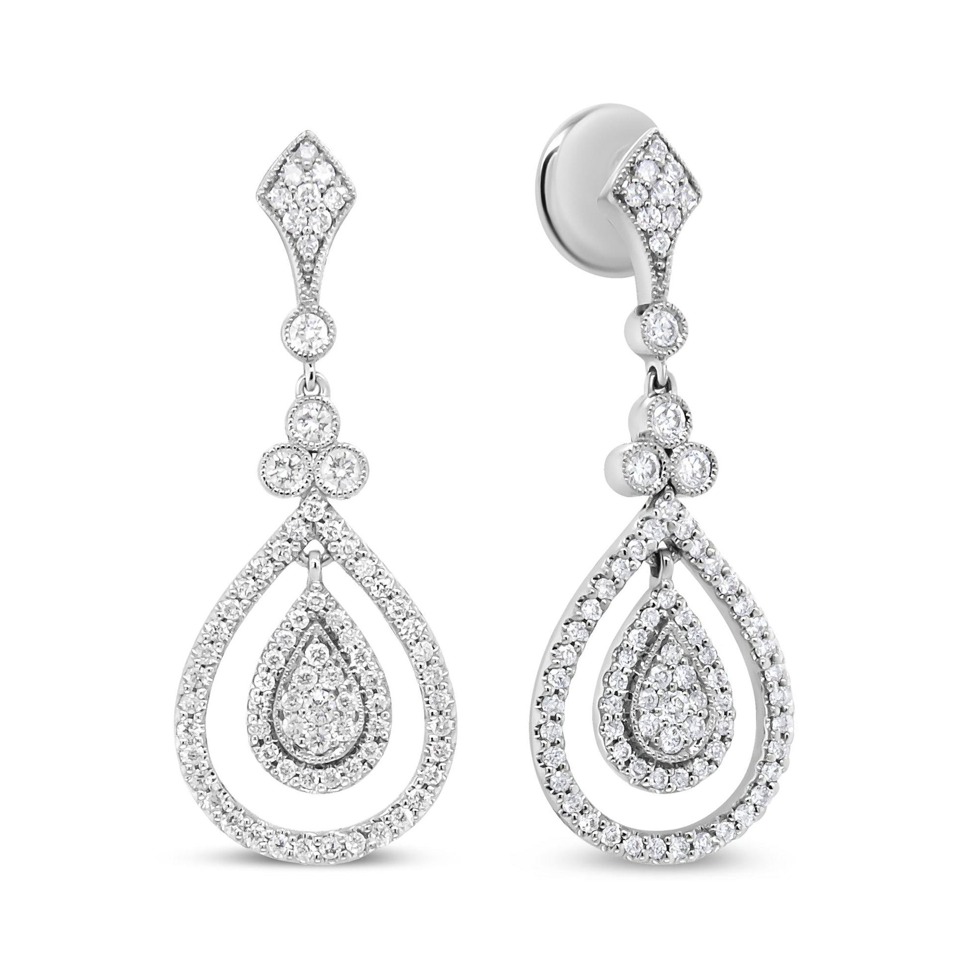 Front-facing view of white metal drop earrings with multiple round white gemstones in bezel and prong settings forming a teardrop shape.