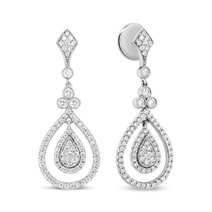 Front-facing view of white metal drop earrings with multiple round white gemstones in bezel and prong settings forming a teardrop shape.