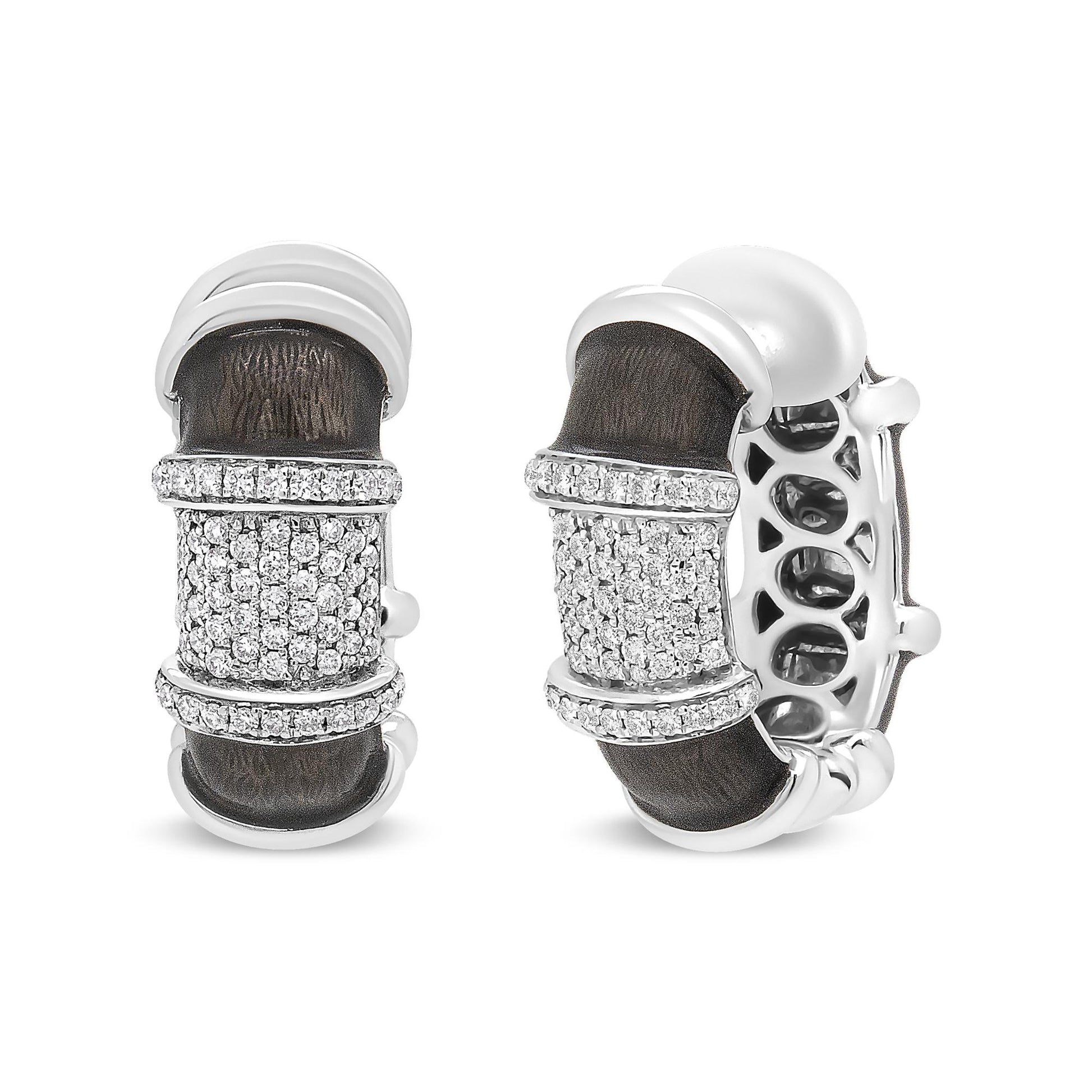 Close-up front and side view of white metal hoop earrings with dark textured inlay and multiple rows of round white gemstones in prong settings on the front.
