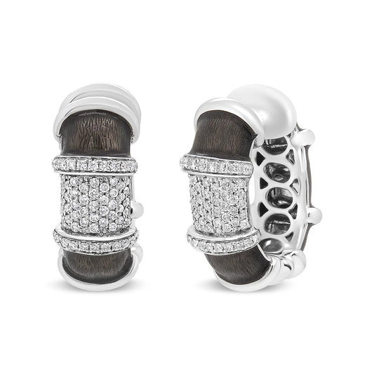 Close-up front and side view of white metal hoop earrings with dark textured inlay and multiple rows of round white gemstones in prong settings on the front.