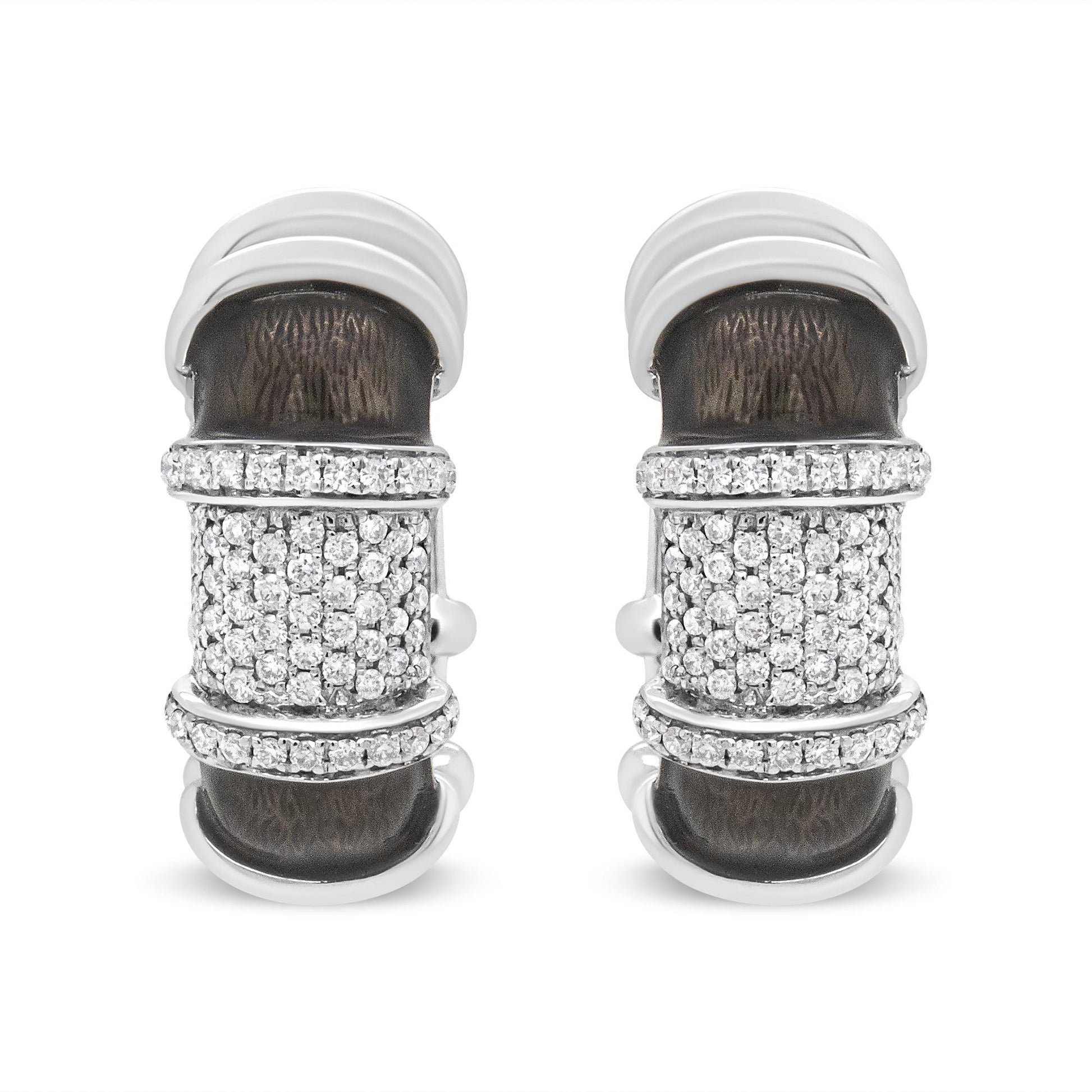 Pair of white metal earrings with textured dark central panels and multiple rows of round white gemstones, shown from the front angle on a white background.