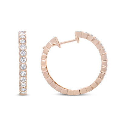 Pair of rose metal hoop earrings with white round bezel-set gemstones, shown from front and side angles on a white background.