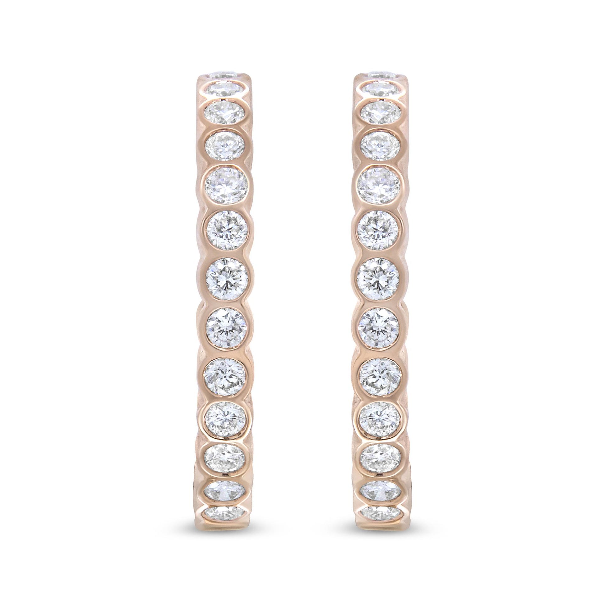 Front-facing close-up of a pair of rose-colored hoop earrings set with round white gemstones in bezel settings along the outer edge.