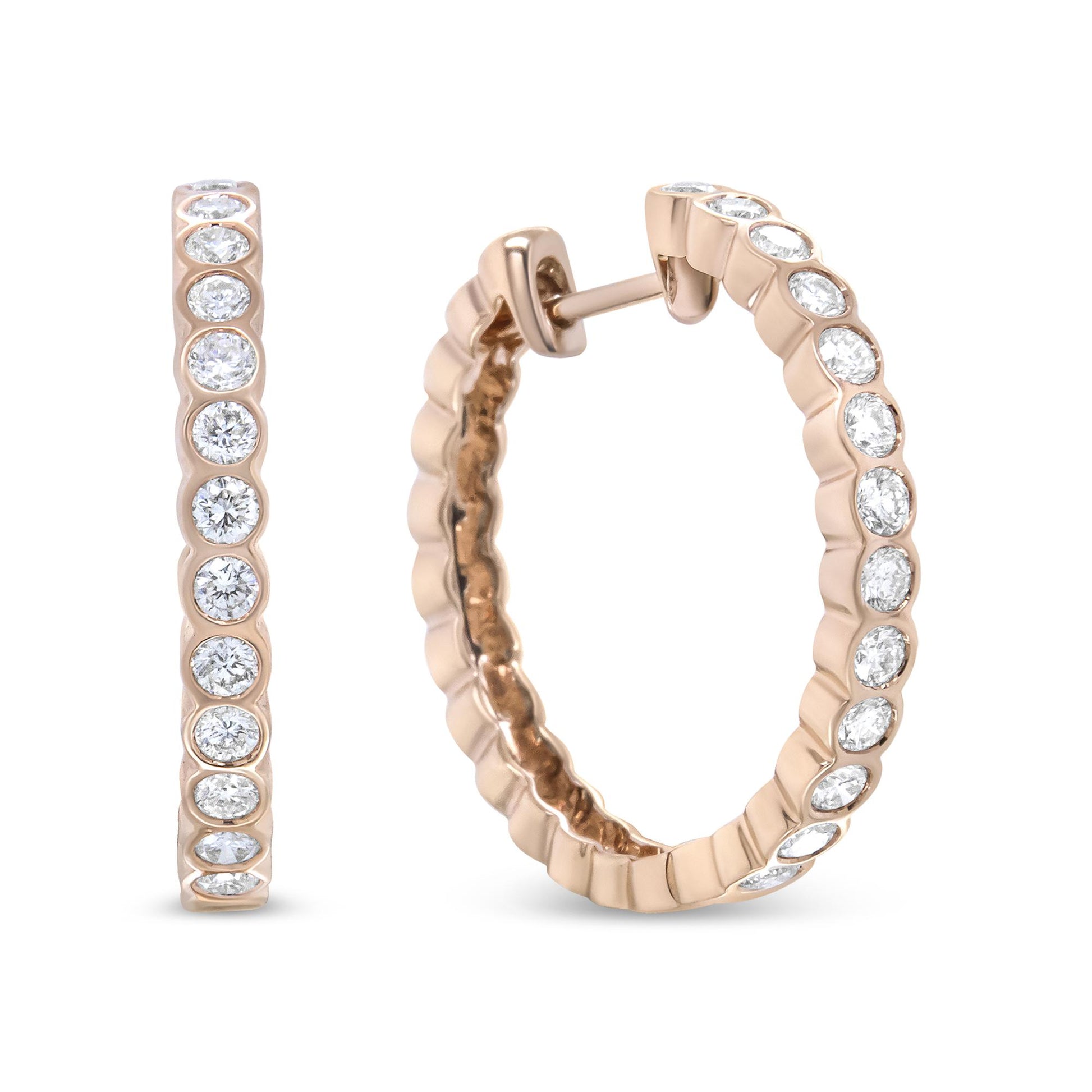 Close-up front and angled view of rose metal hoop earrings with round white gemstones in bezel settings along the outer edge.