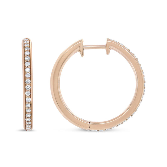 Close-up front and side view of rose metal hoop earrings with small white gemstones in prong settings along the outer edge.