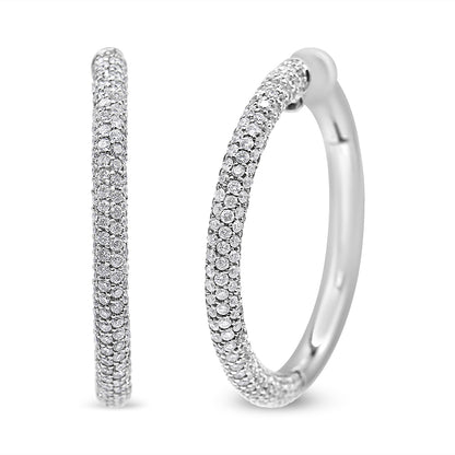 Close-up front and side view of white metal hoop earrings with round white gemstones in pave setting.