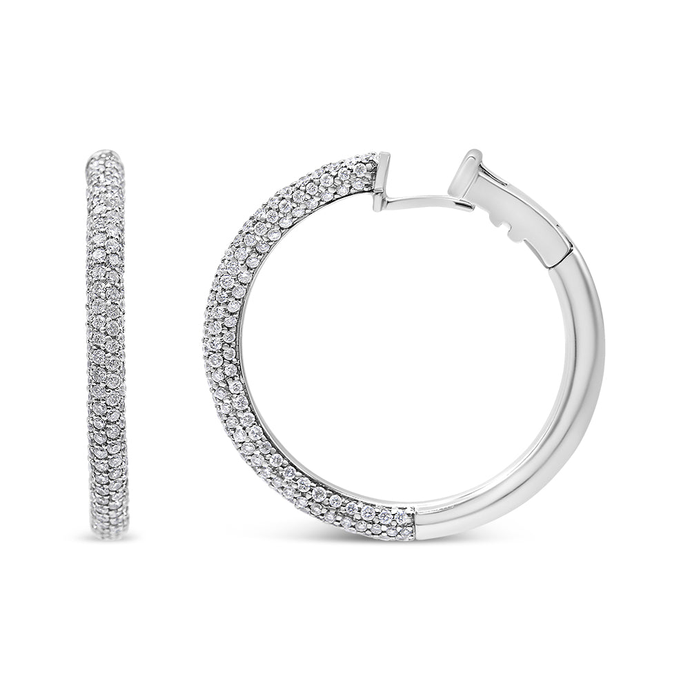 Close-up front and side view of white metal hoop earrings partially encrusted with round white gemstones in pave setting.