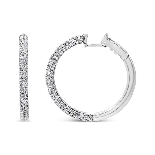 Close-up front and side view of white metal hoop earrings partially encrusted with round white gemstones in pave setting.