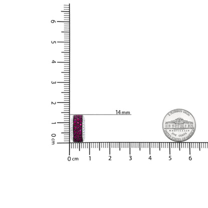 Close-up front view of white metal round hoop earring with rows of red and white round gemstones in prong settings, shown on a ruler and next to a coin for size reference.