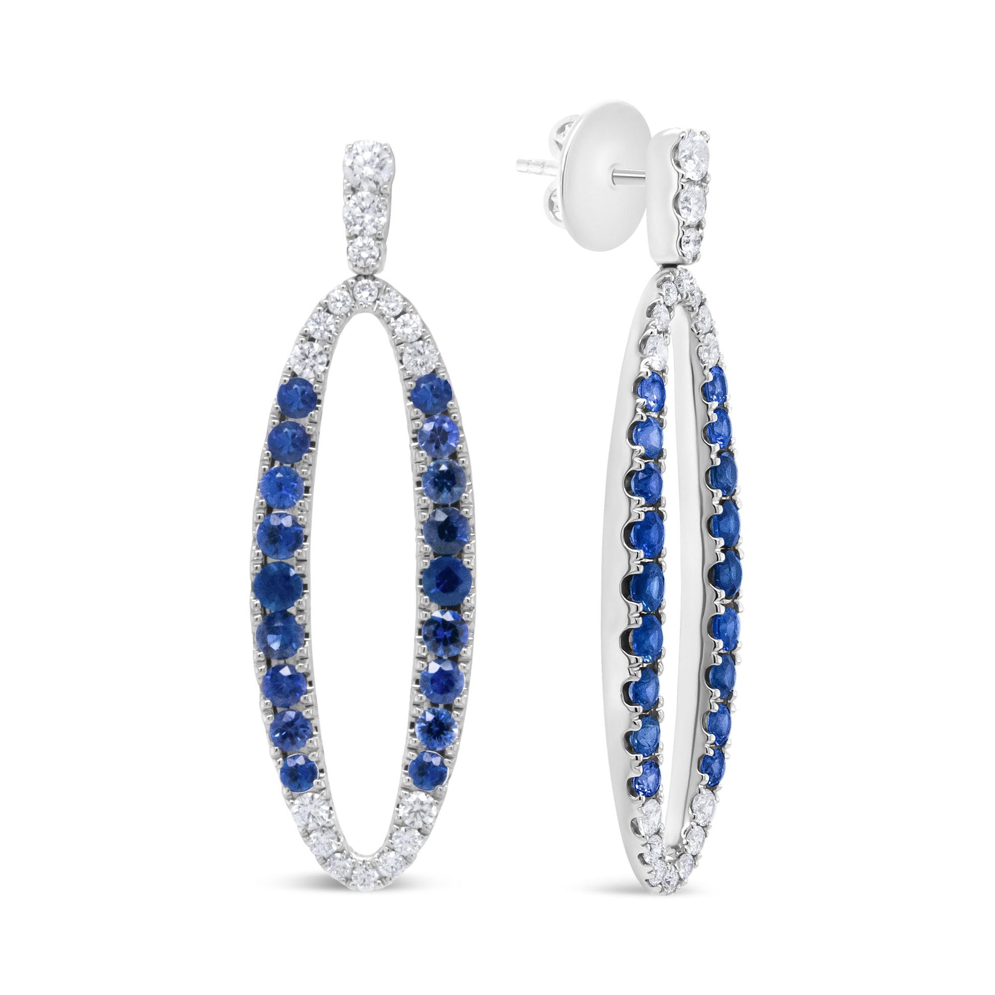 White metal oval-shaped earrings with alternating white and blue gemstones in prong settings, shown from front and side angles.