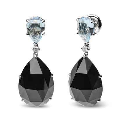 Front angle view of white metal drop earrings featuring pear-shaped blue gemstones at the top, round white gemstones in the middle, and large pear-shaped black gemstones hanging below.