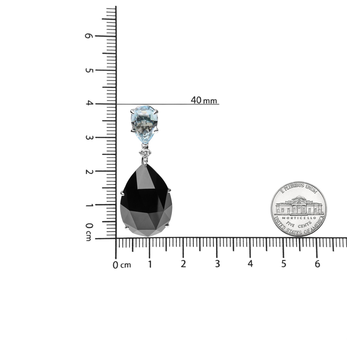 Single white metal earring with pear-shaped blue gemstone on top, round white gemstone below it, and larger pear-shaped black gemstone at the bottom, shown on a ruler and next to a coin for size reference, front view.