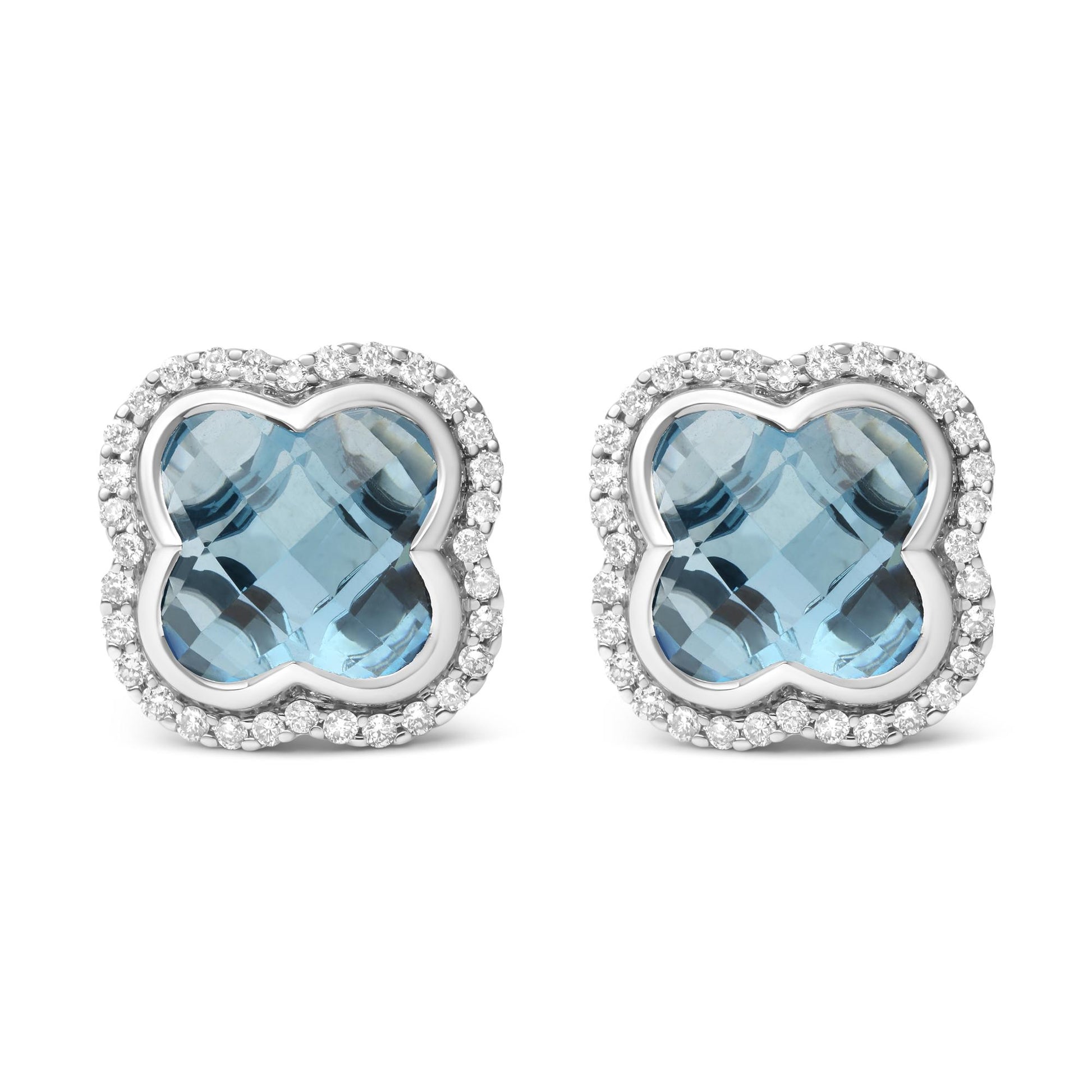 Front view of white metal earrings with a blue gemstone center in a unique shape, surrounded by a border of round white gemstones in prong settings.