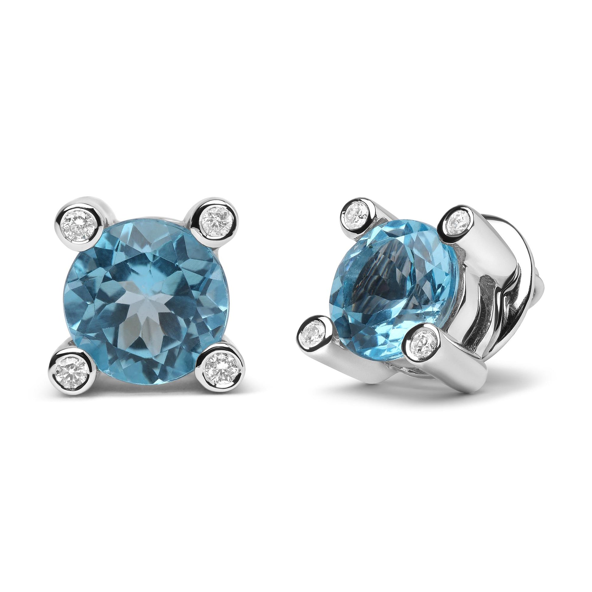Pair of white metal stud earrings with round blue gemstones prong set at the center, surrounded by round white gemstones in bezel settings, front and angled side views on white background.