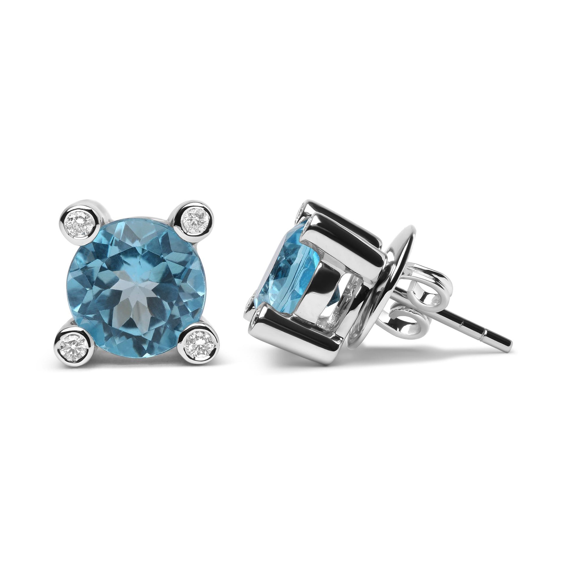 Pair of white metal stud earrings with round blue gemstones in prong settings, each surrounded by four smaller round white gemstones in bezel settings, shown from front and side angles on a white background.