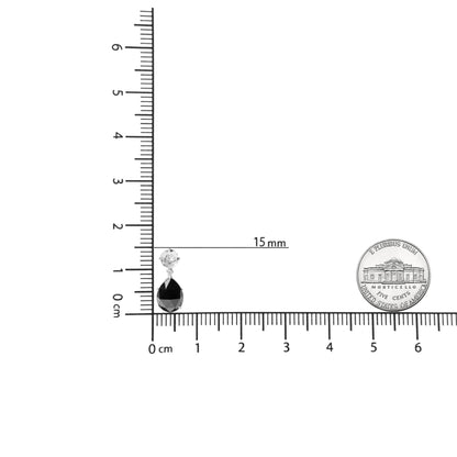 White metal earrings with a black pear-shaped gemstone and a white round gemstone above, shown on a ruler and scale for size reference, front-facing angle.
