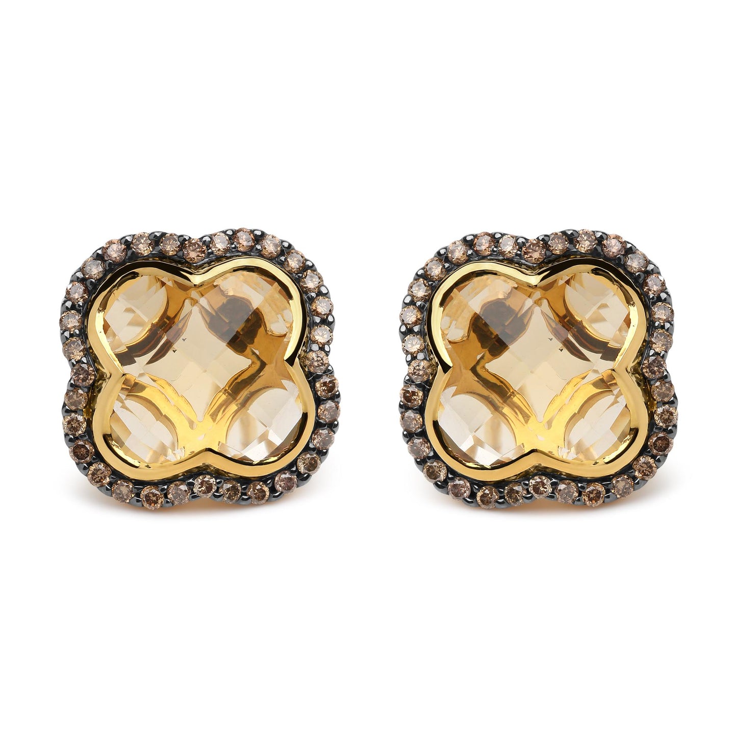 Front-facing close-up of yellow and black earrings with large yellow gemstones in the center surrounded by a border of small brown round gemstones set in prongs.