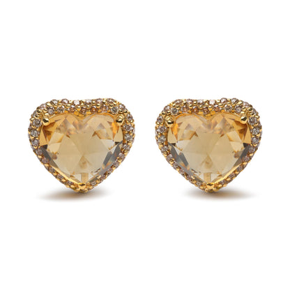 Front view of yellow metal heart-shaped earrings with yellow heart-shaped gemstones surrounded by small round brown gemstones in prong settings.