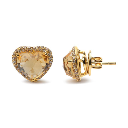 Pair of yellow metal stud earrings with heart-shaped yellow gemstones surrounded by small round brown gemstones, shown from front and side angles.
