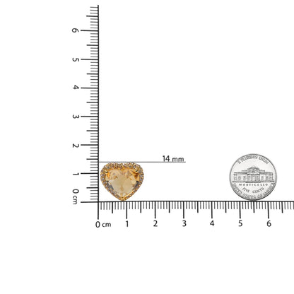 Yellow metal heart-shaped earrings with a central yellow heart-shaped gemstone surrounded by round brown gemstones, shown on a ruler for size reference from a top-down angle.