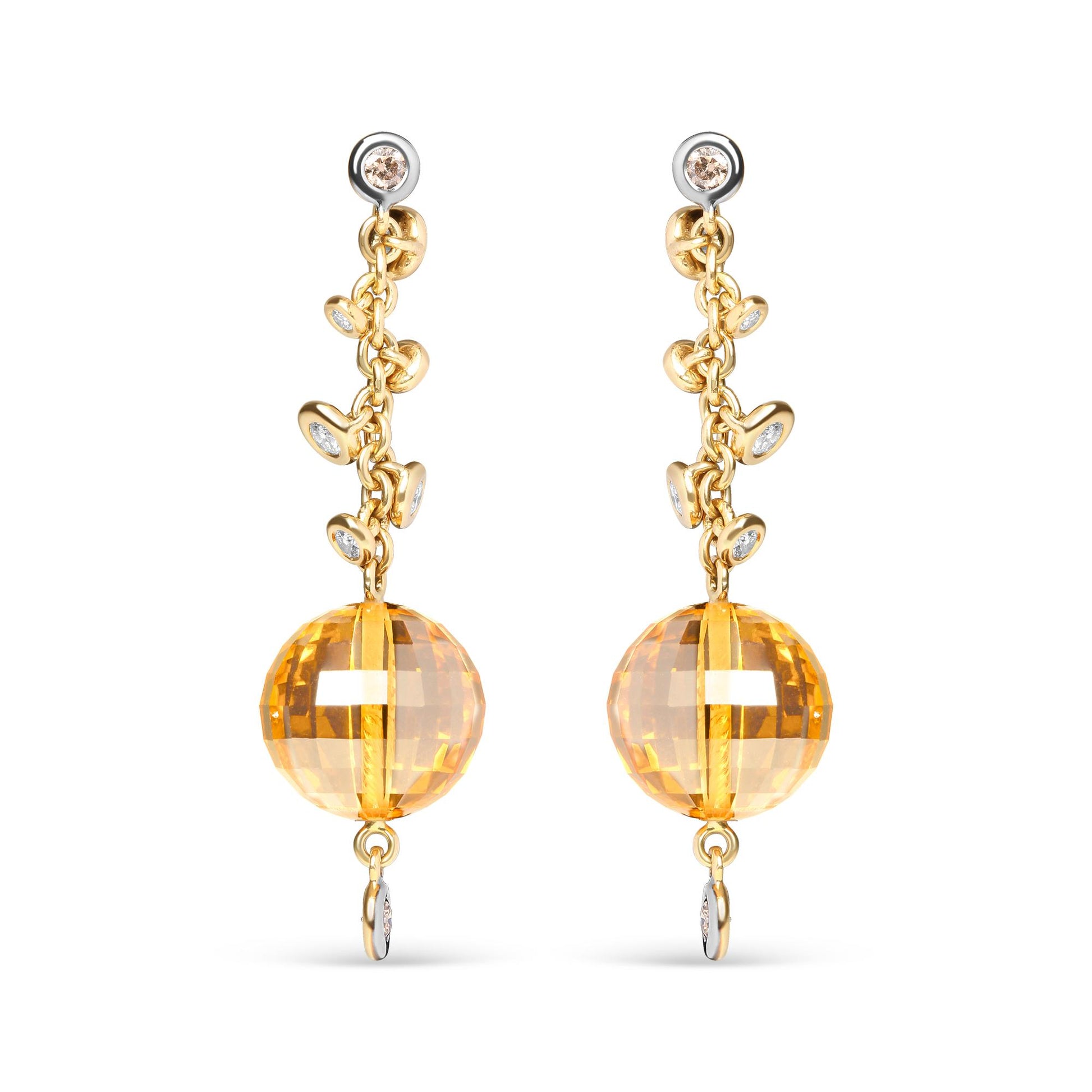 Front view of yellow metal drop earrings with round bezel-set brown and white gemstones along the chain and a large faceted yellow gemstone at the bottom.