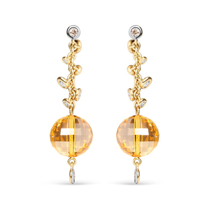 Front view of yellow metal drop earrings with round bezel-set brown and white gemstones along the chain and a large faceted yellow gemstone at the bottom.